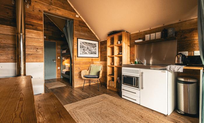 interior of llechwedd glamping tent kitchenette and bedroom area